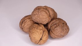 Some walnuts in a bowl slowly spin in a circle - loop able video