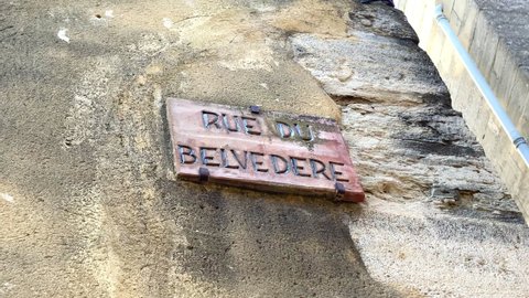 Gordes, France - August 2021 : "Rue du Beledere" streert sign in the old medieval village of  Gordes, France