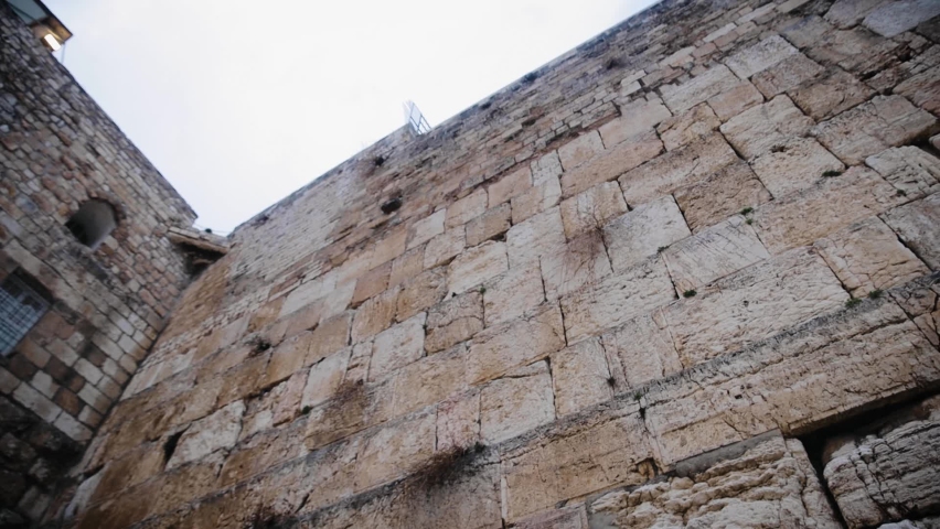 The Old City of Jerusalem, holy place for all jewish people - The Western Wall at Temple Mount. Bird flying close to wall at the end of footage