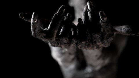 clay female statue with blindfold in darkness, woman is stretching hands dramatically