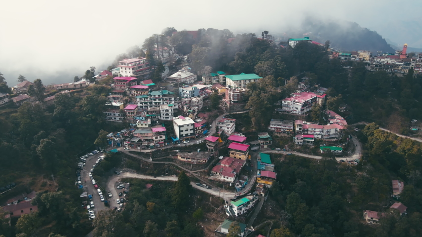 Aerial landscape view of Mussoorie hilltop peak city located in Uttarakhand, India with colorful buildings. Mussoorie Hill station near Dehradun in Uttarakhand Himalayan Range. | Shutterstock HD Video #1086468857