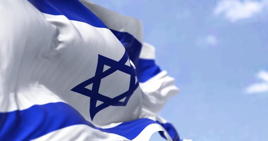 Detail of the national flag of Israel waving in the wind on a clear day. Democracy and politics. Patriotism. Selective focus. Seamless Slow motion | Shutterstock HD Video #1086469394