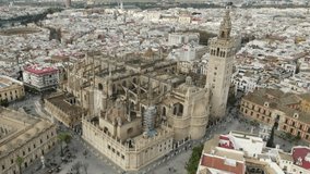 Seville Cathedral with city in background, Spain. Aerial circling