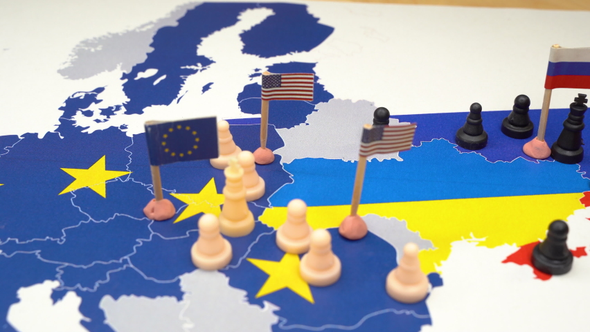 EU, USA and Russian flags with chess pieces symbolizing the conflict and control of Ukraine