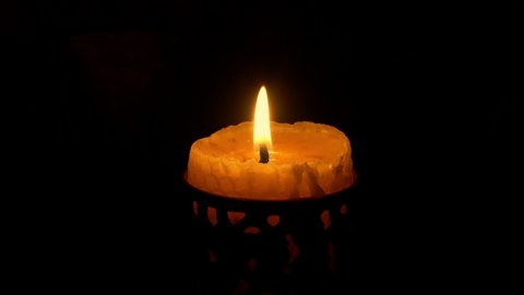 Candle In Holder Lit In The Dark And Burns, Blows Out