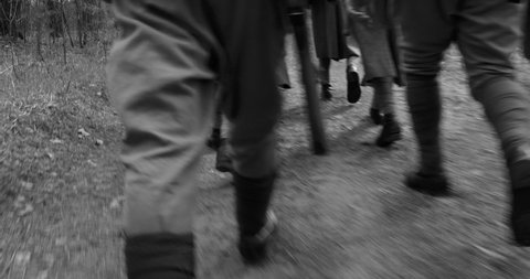 4K Squad Men Dressed As World War II Russian Soviet Red Army Soldiers Marching Through Spring Forest In Sunny day. Black And White WWII WW2 Times.