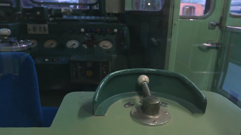 Nagoya.Japan-October 31.2019: A train locomotive cab in the railway museum in Nagoya Japan. Drivers working area. Old technology. Camera slowly tilting upwards while turning left.