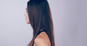Thumbs up to looking after your skin. 4k video footage of a beautiful young woman with gorgeous hair showing thumbs up in the studio.