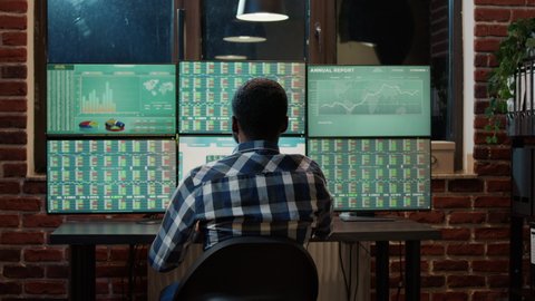 Forex trader analyzing market charts to plan commodities exchange on multi monitor workstation. Financial investment with banking profit statistics and real time stocks changing.