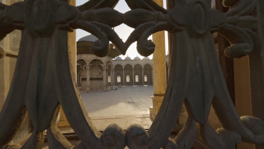Great Mosque of Muhammad Ali Pasha or Alabaster Mosque in Cairo, Egypt. Sun breaks through the lattice of window in the mosque Muhammad Ali Pasha, courtyard is visible inside. Citadel of Cairo. Gimbal