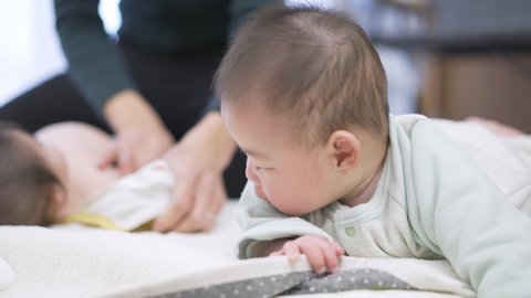 Asian baby happy to turn over