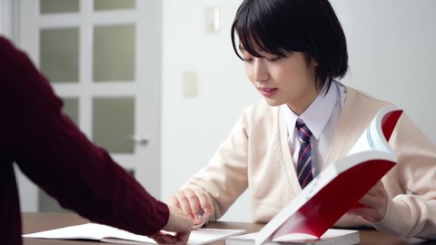 Asian female high school student and teacher in classroom. Cram school. Preparatory school. Home tutor.