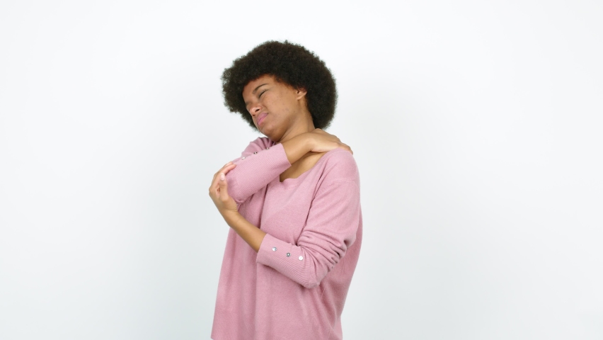 Young African American woman with shoulder pain over isolated background