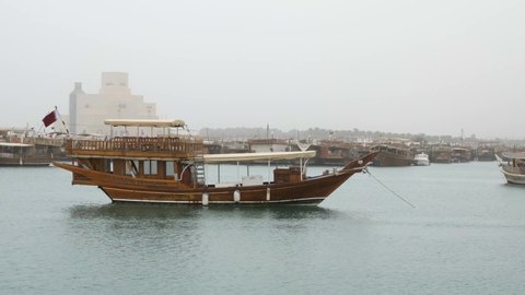 A traditional wooden Qatari dhow boat moored in Dhow harbour, Doha, Qatar