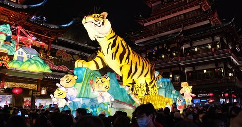 Shanghai.China-Feb.1st 2022: crowded tourists in face mask at Yu Garden to watch lantern show of tiger during traditional Chinese new year(Year of the Tiger)