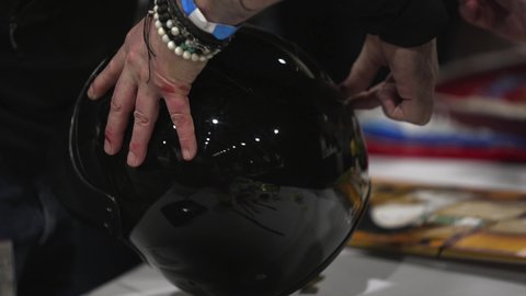 Los Angeles, CA USA - Jan 20 2022: This close up video shows an artist designing and drawing on a black motorcycle helmet.