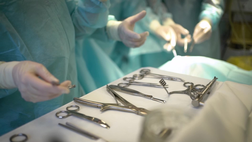 the assistant passes surgical instruments during the operation Royalty-Free Stock Footage #1086510197