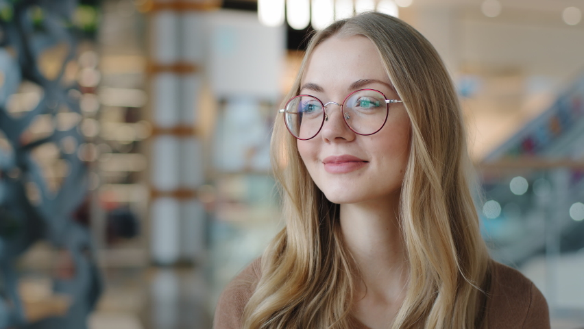 Head shot happy portrait caucasian girl in glasses young woman satisfied with ophthalmology services millennial blonde with healthy white toothy smile looking at camera confident model posing indoors Royalty-Free Stock Footage #1086512624