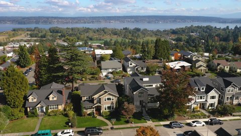 Aerial view of Everett, WA (Seattle area) on a sunny day with Lake Washington in the background, rising up to show neighborhood houses and parks