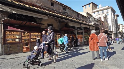 Florence, Italy. January 2022.  view of tourists walking among the shops on the Ponte Vecchio over the Arnon River in the city center
