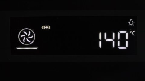 Setting cooking modes and oven temperature. Cooking, baking. LCD display of kitchen appliances. White numbers and symbols on a black background.