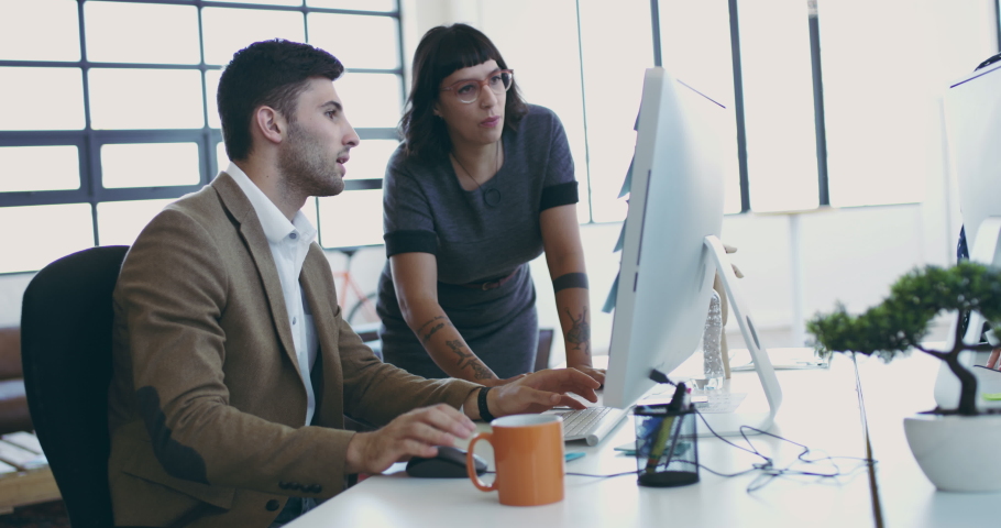 Hard at work in the office. 4K video footage of a diverse group businesspeople working together in a modern office.