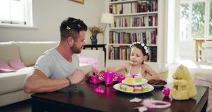 Daddy has vip access to my royal tea party. 4k video footage of a father and his little daughter having a tea party together at home.