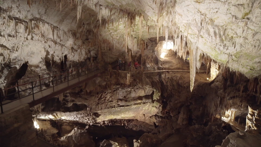 Family exploring the interior of Postojna Cave in massive cavern Royalty-Free Stock Footage #1086522248