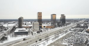 Southfield, Michigan skyline in winter with drone video moving in.