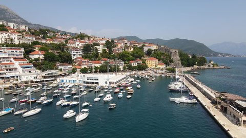 Aerial View of Herceg Novi Harbor, Montenegro. Moored Boats and Anchored Sailboats on Sunny Summer Day
