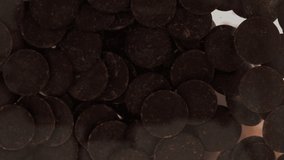 Bottom view of dark chocolate chips falling from a bowl on a transparent background and filling up the entire space. Chocolate chips falling on camera. Cooking. - Powered by Shutterstock - Get 15% off with code: PIKWIZARD15