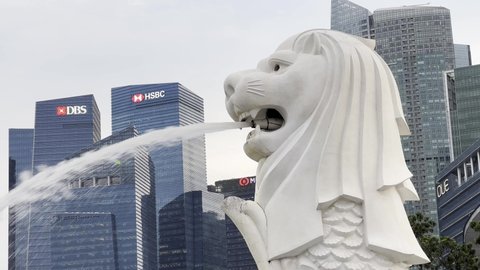 Central Area , Singapore - 01 25 2022: Close up of iconic Singapore mascot, mythical creature merlion at downtown metropolitan area with business and financial buildings in the background
