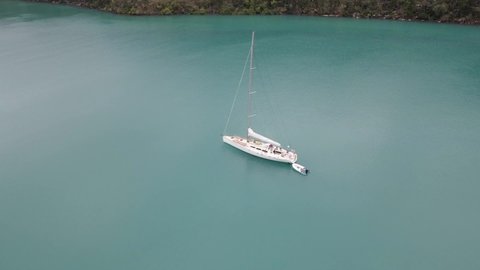 Tourists At Sailboat With Dinghy Floating At Tranquil Waters Of Nara Inlet - Boat Tour At Whitsunday Island, QLD, Australia. - aerial