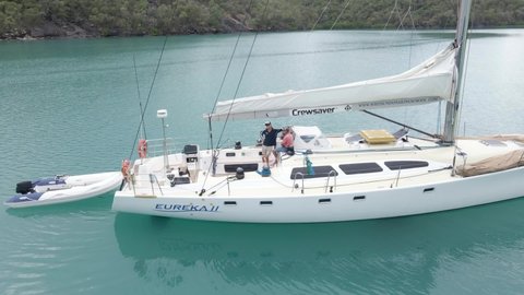 QLD , Australia - 12 01 2021: EUREKA II Sailboat With Dinghy At Nara Inlet Exploring The Whitsunday Island