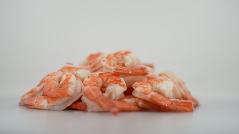 Shrimps are Rotating on Turntable. Isolated on the White Background. Seafood. Close up