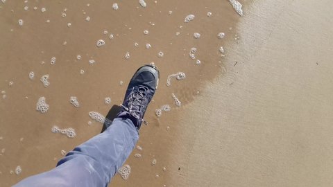  Walk along the wet sandy beach in the off-season. Walking along the sandy seashore on the water, first-person view