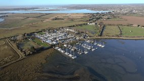 Thornham Marina situated in the Prinstead Estuary Channel on the Southern Coast of England, aerial footage.