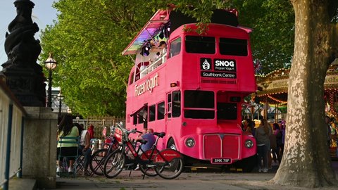LONDON - JUNE 01, 2021: Double Decker bus converted to a frozen yoghurt bar on Southbank on a summer evening