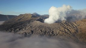 Aerial view of Mount Bromo volcano covered with thick mist at sunrise, Surabaya, Java, Indonesia
