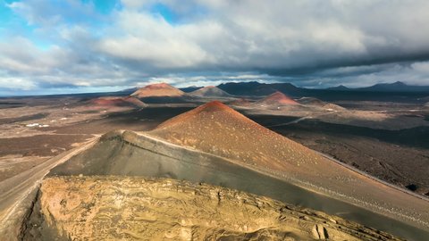 Top view of Lanzarote volcanoes. Drone flight over Lanzarote island in the morning. Aerial view of Canary islands, Spain. landscape with volcanoes in the morning light. Sunrise over the volcanoes.