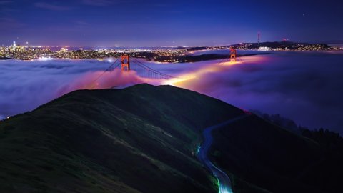 Golden Gate Bridge with flowing fog timelapse at night, San Francisco , California