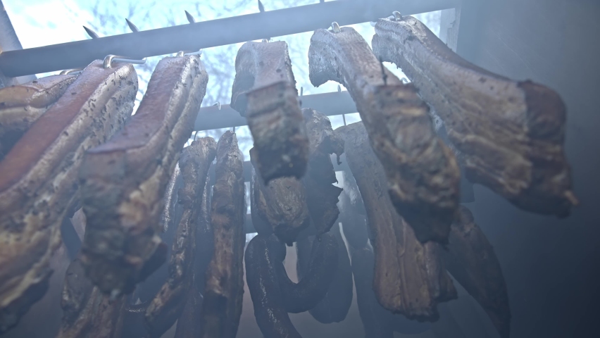 Sausages and beacons is hanging inside wooden smoker | Shutterstock HD Video #1086556322