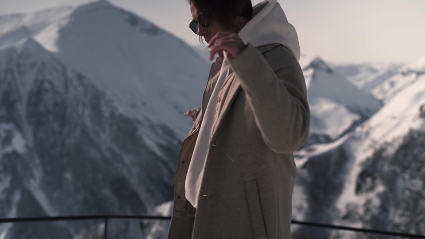 The boy is dancing in the snowy mountains