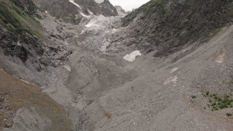 Trekking in Ushguli to Glacier Shkhara in Caucasus Mountains. Stones on bank of Enguri river around Mt. Shkhara, highest peak of Georgia. Svaneti, Georgia.