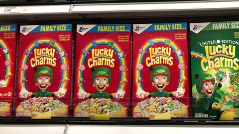 Alameda, CA - Feb 6, 2022: 4K HD video panning across grocery store shelf with boxes of Lucky Charm's cereal. Original, Limited Edition Magic Clovers and Chocolate 
