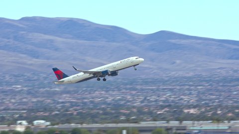 LAS VEGAS, NV - 2022: Delta Air Lines Airbus A321 Jet Airliner Taking off from Las Vegas LAS Harry Reid International Airport Runway in Nevada with the City’s South Neighborhoods in the Background