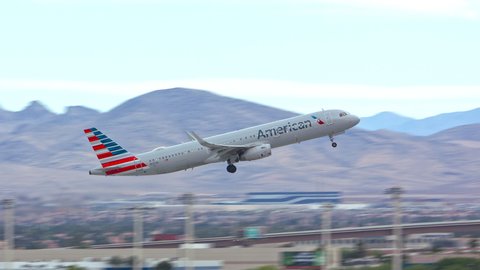 LAS VEGAS, NV - 2022: American Airlines Airbus A321 Jet Airliner Taking off from Las Vegas LAS Harry Reid International Airport Runway in Nevada with the City’s South Neighborhoods in the Background