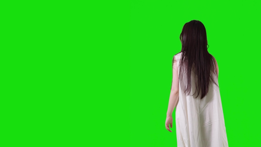 Young asian woman wearing white dress. Green background for chroma key composition.