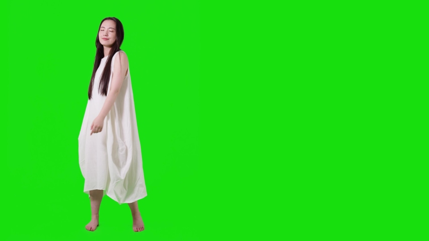 Young asian woman with white dress. Green background for chroma key composition.