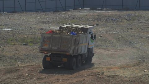 Pune, India - February 05 2022: A dumper truck in action at an open plot of land at Pune India.